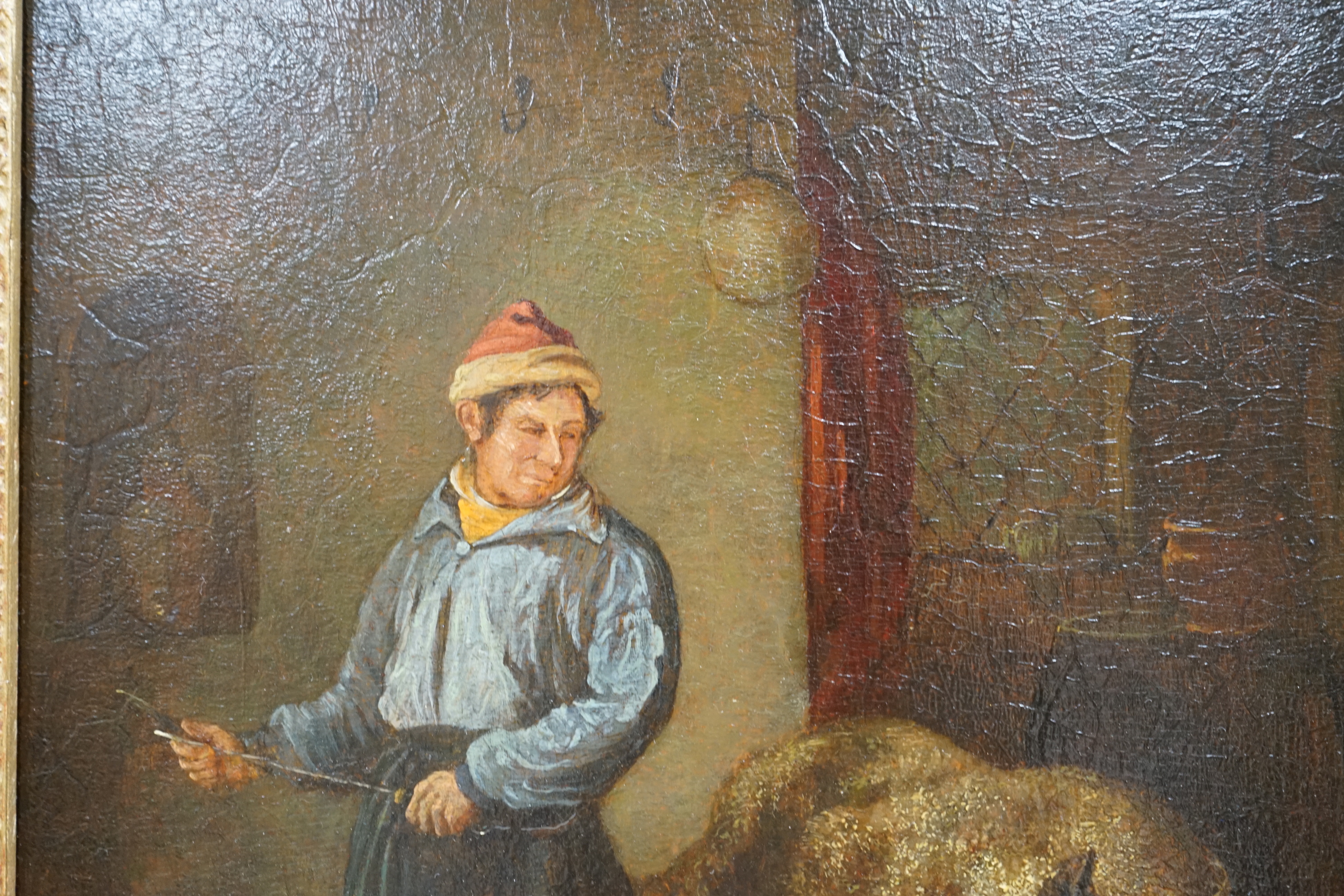 After George Morland (1763-1804), oil on oak panel, Interior with a figure preparing to butcher a pig, unsigned, 31 x 25cm